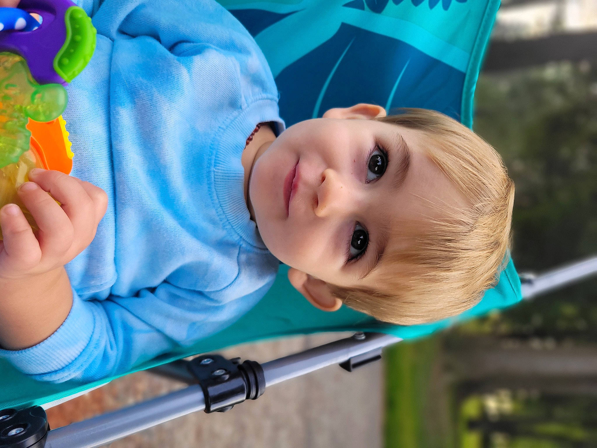 Zayd is registered to the contest to win money with this photo: baby, baby_playing_with_toys, baby_products, baby_toddler_clothing, cheek, child, city, electric_blue, facial_expression, fun, grass, green, happy, joy, leisure, person, play, recreation, skin, smile