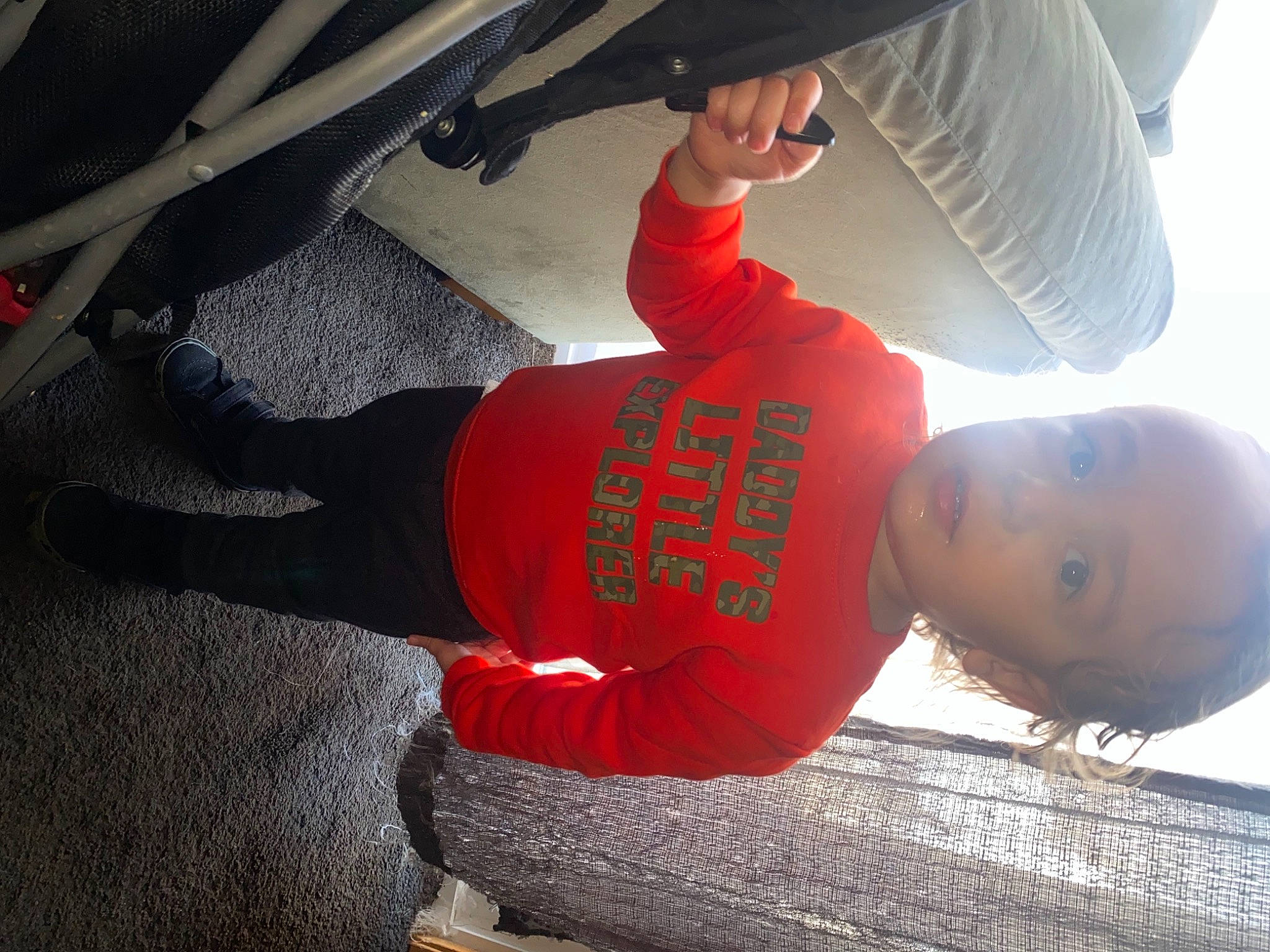 Kevin is registered to the contest to win money with this photo: automotive_tire, carmine, child, comfort, elbow, flooring, fun, hat, human_leg, joint, knee, leg, leisure, person, shorts, sitting, sneakers, sportswear, t_shirt, thigh