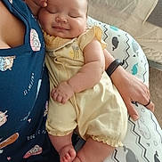 Kalista joined the competition — help win amazing prizes! baby, sleeping, infant, yellow_outfit, adult, navy_shirt, dog_prints, cushion, whale_pattern, hand, arm, skin, comfort, rest, indoor, soft_lighting, closeup, peaceful, cute, smile