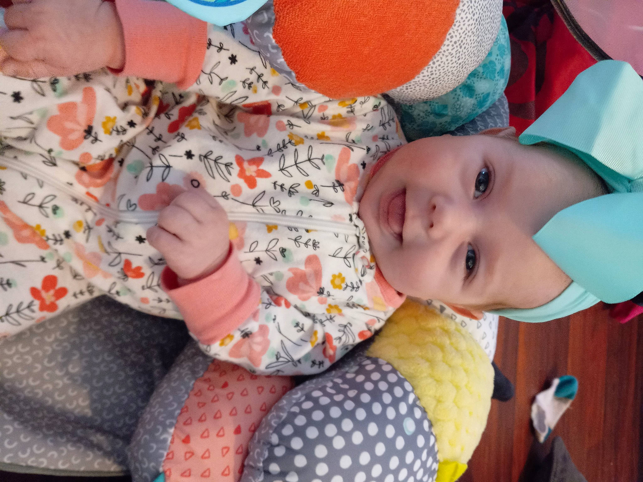 Amelia joined the competition — help win amazing prizes! baby, baby_toddler_clothing, cheek, child, comfort, eye, finger, happy, human_body, human_leg, mouth, nose, orange, pattern, person, sitting, skin, smile, textile, toddler