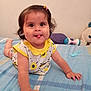 Laya Aurora joined the competition — help win amazing prizes! baby, child, infant, tongue_out, playful, bed, bedspread, toy, pillow, hairclip, smile, room, crawling, cute, yellow, patterned_clothing, happy, indoors, person, young_child