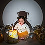 toddler, child, birthday_cake, candle, balloons, pigtails, white_sweater, yellow_skirt, celebration, party, shadow, spotlight, indoor, cute, cake, decorations, anniversary, one_year, birthday, happy