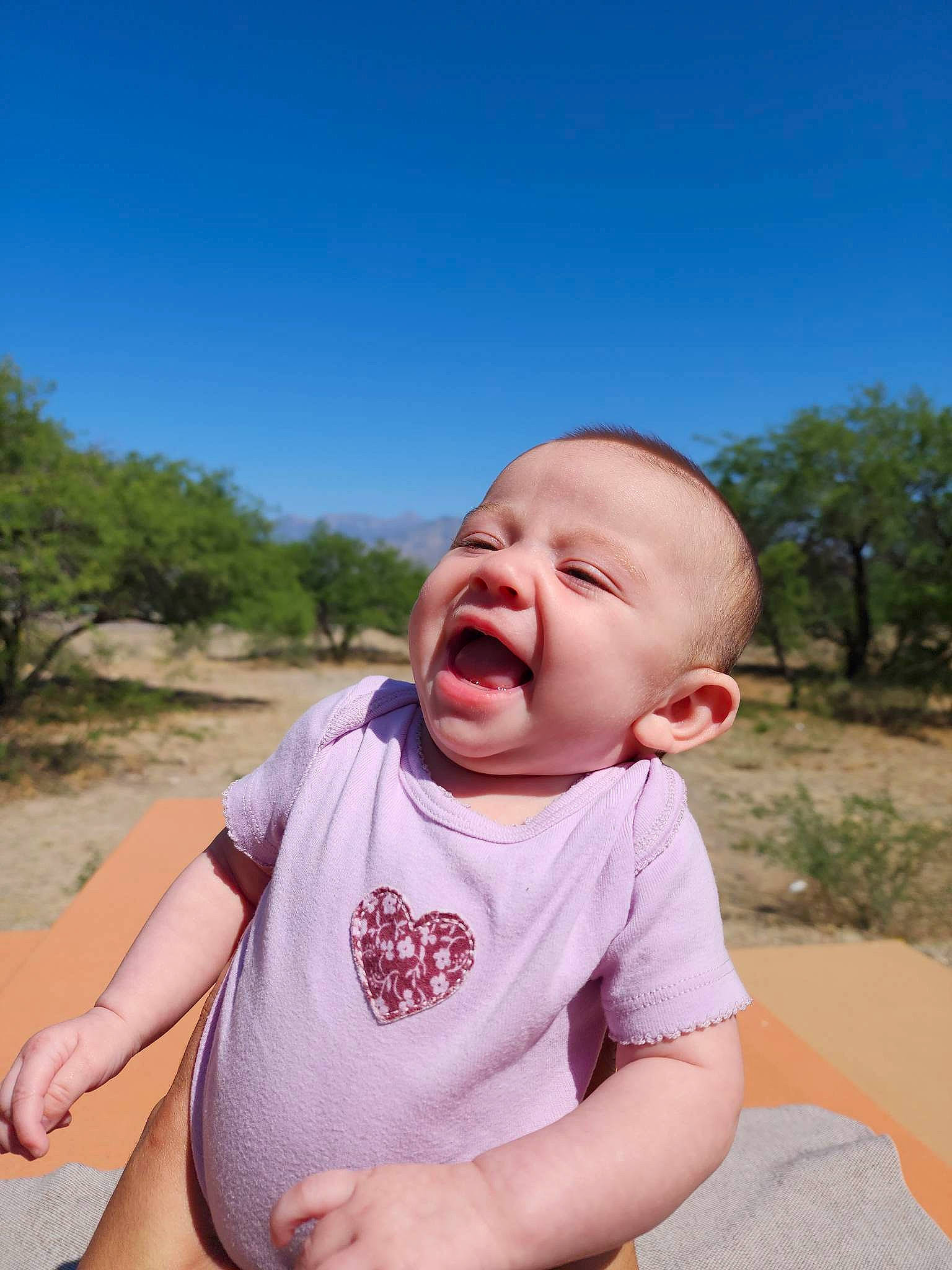 Sophiamarie is registered to the contest to win money with this photo: baby, baby_toddler_clothing, child, fun, gesture, grass, happy, leisure, lip, mouth, nose, people_in_nature, person, plant, recreation, skin, sky, sleeve, summer, toddler
