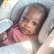 Kuot joined the competition — help win amazing prizes! baby, child, car_seat, seat_belt, clothing, infant, face, eyes, padded_strap, indoor, seat, head_support, safety, young_child, person, cute, looking_at_camera, casual, warm_light, portrait