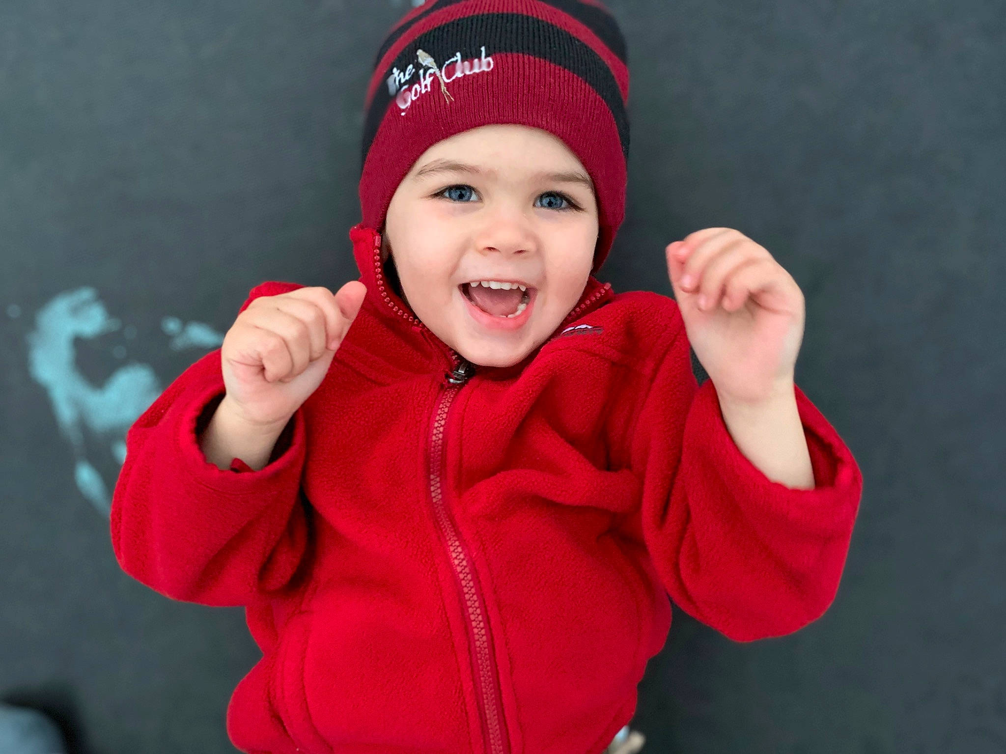 Avian is registered to the contest to win money with this photo: beanie, cap, child, child_model, facial_expression, finger, fun, gesture, hand, happy, headgear, headwear, jacket, joy, knit_cap, laugh, outerwear, person, red, smile