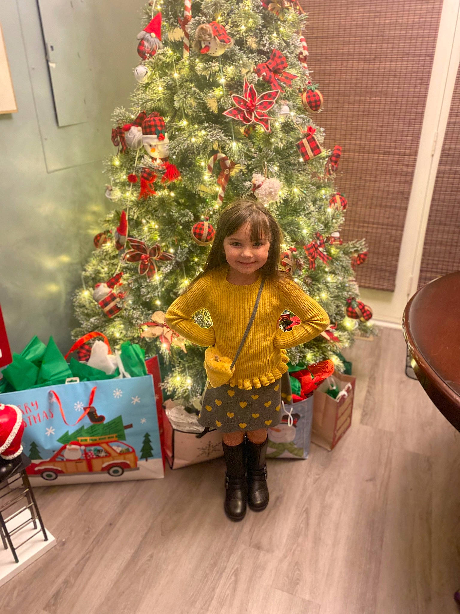 Kyla joined the competition — help win amazing prizes! christmas, christmas_decoration, christmas_eve, christmas_ornament, christmas_tree, conifer, event, evergreen, flooring, fun, holiday, holiday_ornament, joy, ornament, person, plant, room, smile, toddler, tradition