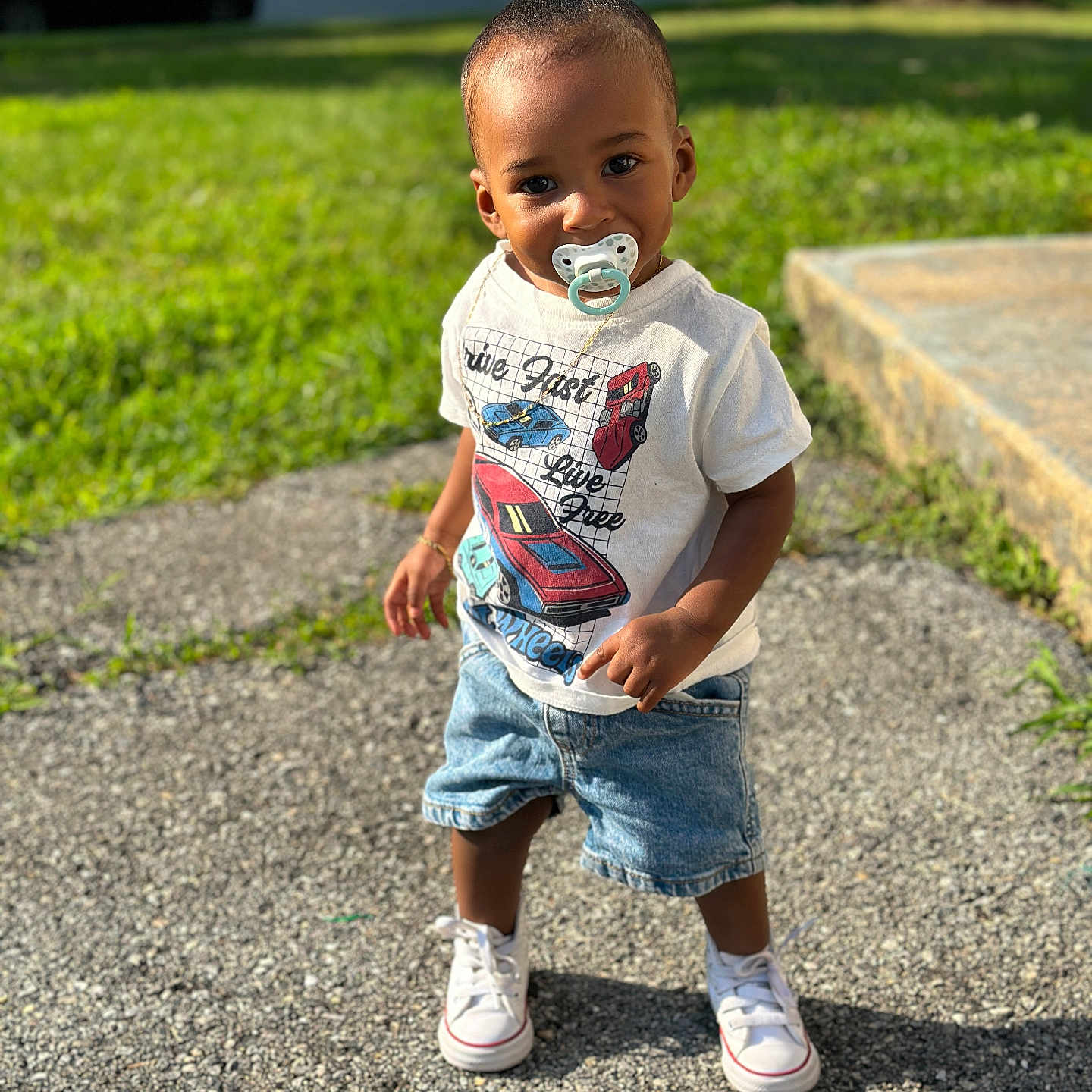 Kross is registered to the contest to win money with this photo: casual_clothing, child, concrete, cute, daylight, grass, happy, outdoor, pacifier, portrait, shorts, sidewalk, small_pony_tail, standing, summer, sunlight, toddler, tshirt, white_shoes, young_child