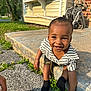 Kross joined the competition — help win amazing prizes! toddler, child, smiling, outdoor, concrete, grass, greenery, sunlight, striped_shirt, black_socks, bracelet, necklace, sidewalk, house, window, brick_wall, happy, cute, playful, nature