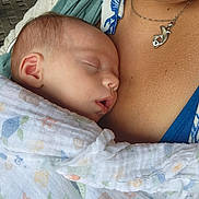 Joy is registered to the contest to win money with this photo: baby, sleeping, blanket, person, necklace, dolphin, closeup, skin, warm, comfort, peaceful, infant, wrapped, soft, rest, cuddle, portrait, human, face, calm