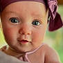 Parker is registered to the contest to win money with this photo: baby, infant, face, headband, purple, bow, close_up, portrait, cute, child, skin, eyes, expression, soft_light, indoor, young, person, headwear, curious, adorable