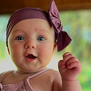 Parker joined the competition — help win amazing prizes! baby, child, headband, bow, face, skin, hand, expression, portrait, indoors, cute, infant, closeup, apparel, person, young, pink, soft_focus, chubby, eyes