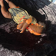 Jamarcus is registered to the contest to win money with this photo: baby, blanket, camo_clothing, child, crying, expression, fabric, face, foot, hair, hand, head, indoor, infant, orange_text, person, shadow, skin, sunlight, texture