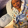 Jamarcus is registered to the contest to win money with this photo: baby, blanket, child, clothing, comfort, cozy, cute, expression, furniture, happy, hood, indoor, infant, person, portrait, robe, seated, smiling, soft, warm