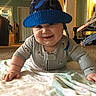 Michael joined the competition — help win amazing prizes! baby, smiling, hat, blue_hat, pajamas, crawling, blanket, indoor, living_room, carpet, child, cute, happy, face, chubby_cheeks, person, home, floor, toy, furniture
