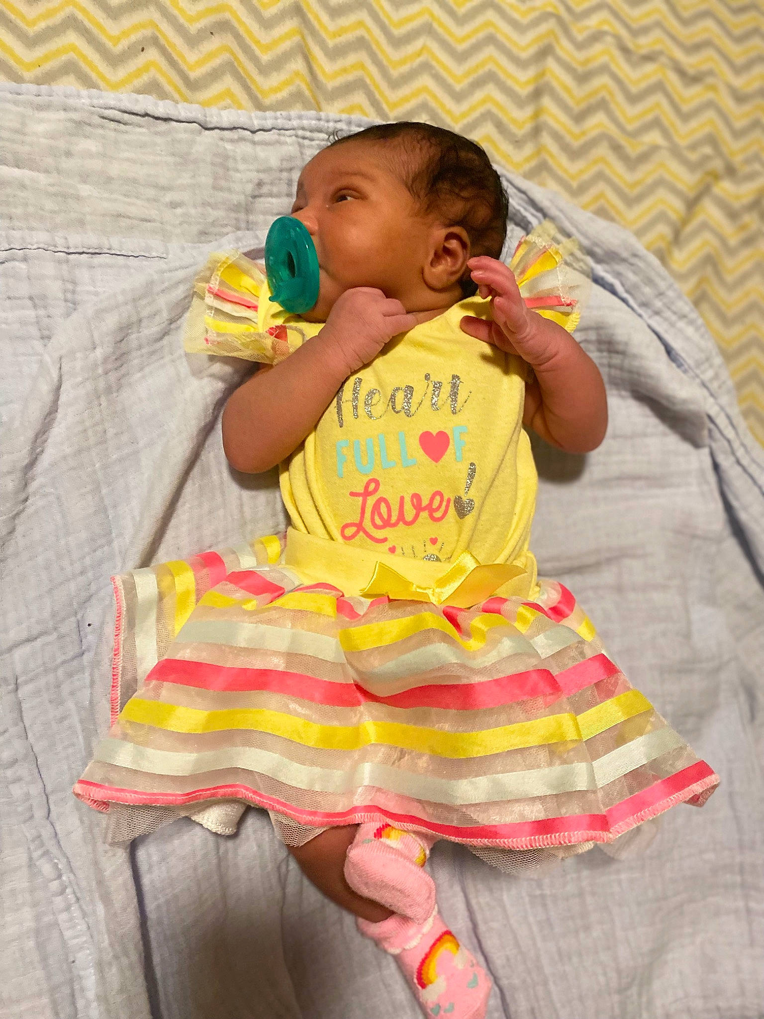 Khalani joined the competition — help win amazing prizes! baby, baby_products, baby_toddler_clothing, child, comfort, event, fun, happy, linens, magenta, pattern, person, pink, play, ruffle, sitting, sleeve, sock, t_shirt, textile