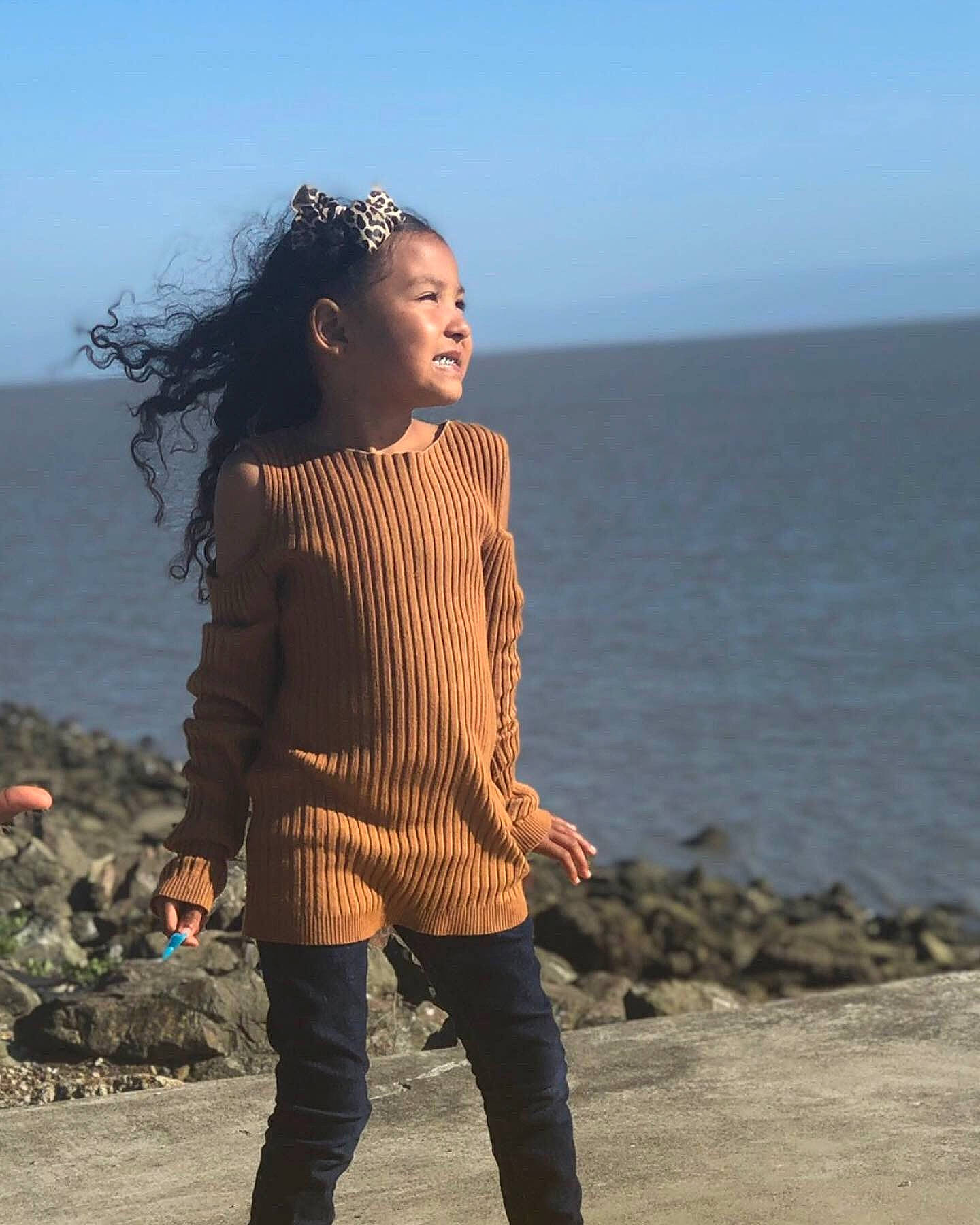 Jordynn is registered to the contest to win money with this photo: beach, beauty, black_hair, fashion, fawn, fun, human, long_hair, neck, ocean, outerwear, person, photography, sea, sky, smile, standing, vacation