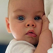 Giany a rejoint le concours — aidez-le/la à gagner de superbes lots ! baby, blue_eyes, cheek, child, close_up, clothing, curious, cute, expression, face, hand, indoor, infant, person, portrait, resting, skin, soft_lighting, white, young