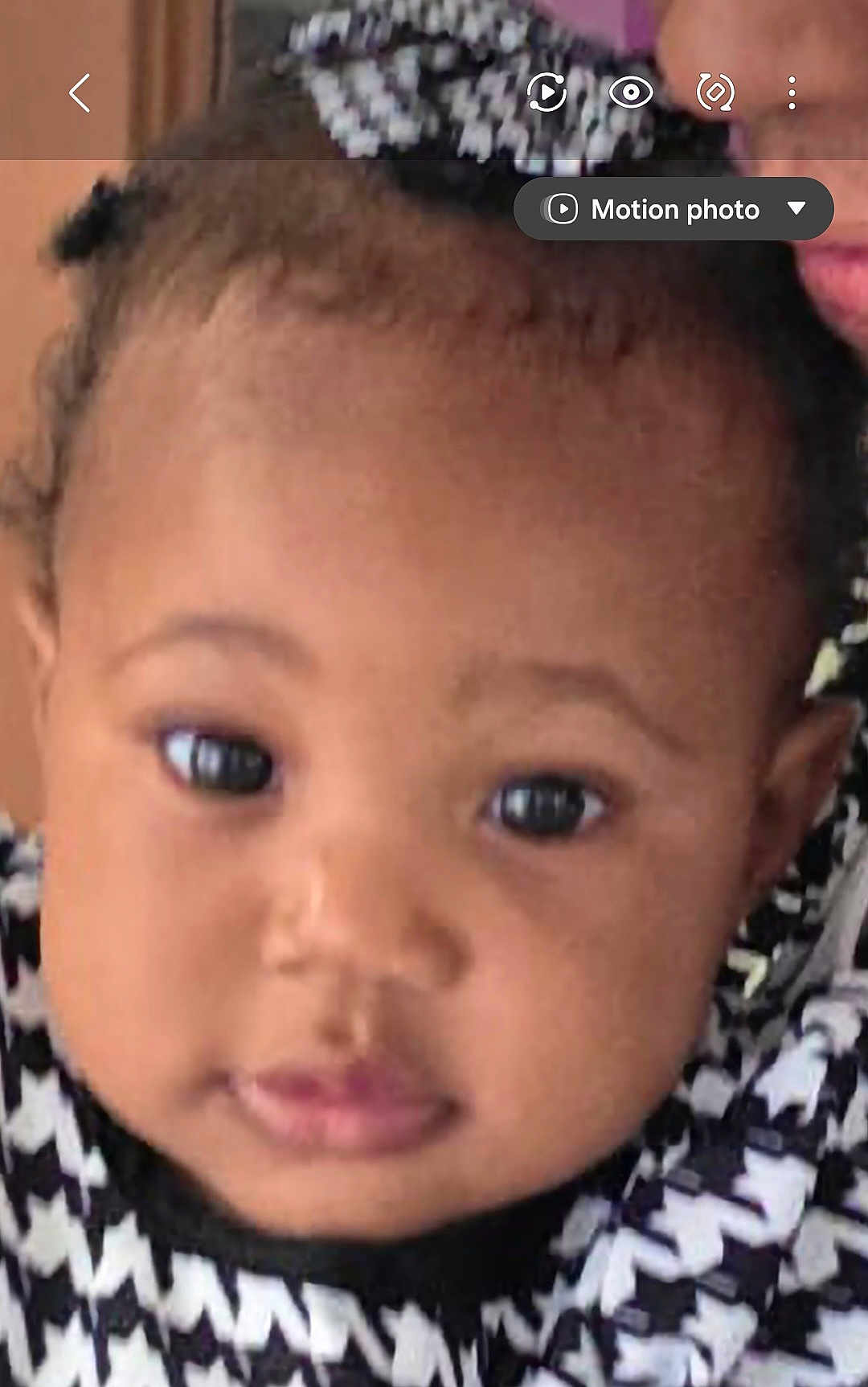 Heart is registered to the contest to win money with this photo: baby, close_up, face, child, infant, cute, black_and_white, patterned_clothing, headwear, portrait, young_child, adorable, curious_eyes, soft_background, indoor, person, expression, childhood, small_hands, young_baby