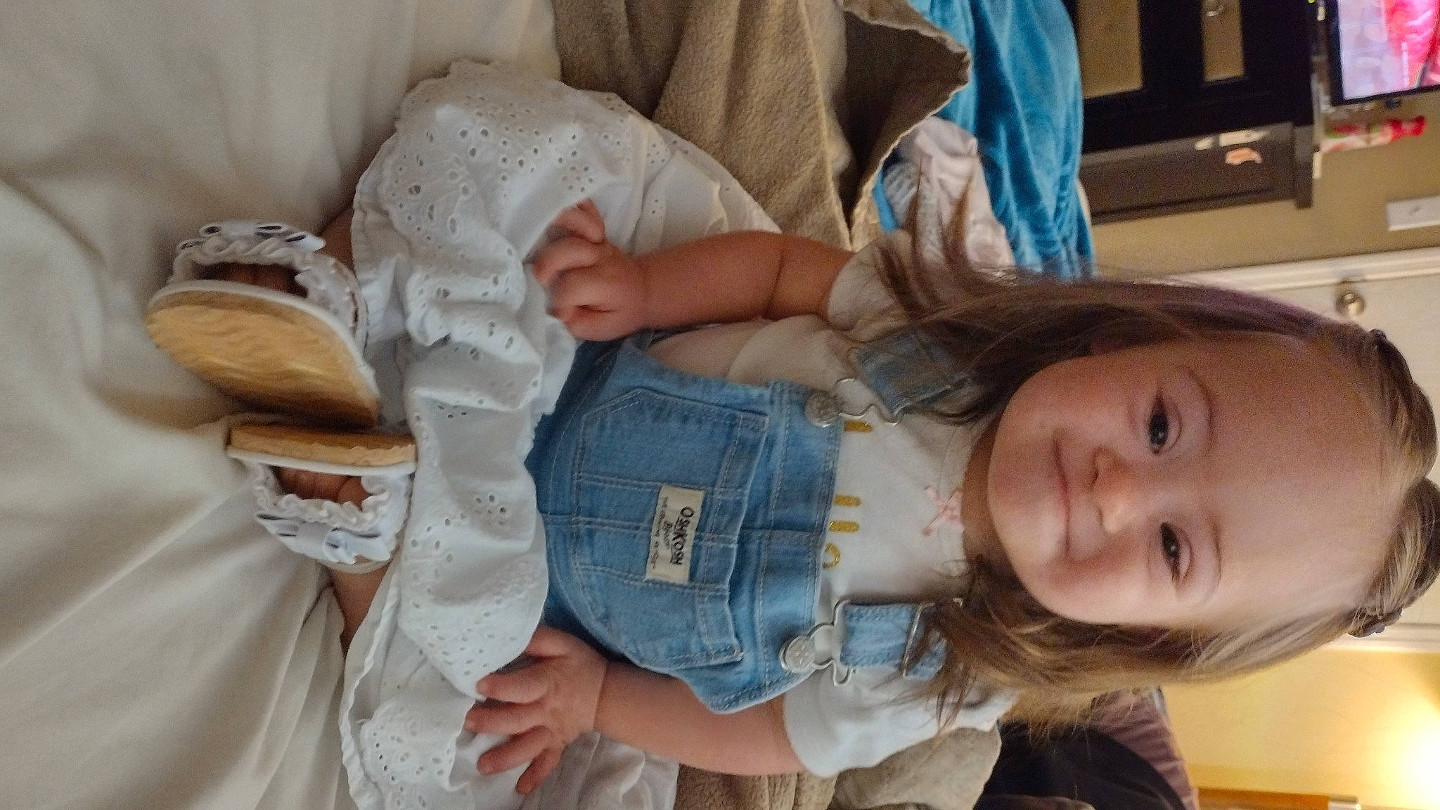 Aurora is registered to the contest to win money with this photo: abdomen, baby_toddler_clothing, cheek, child, comfort, gesture, hand, human_body, joint, joy, linens, mouth, nose, person, room, sitting, skin, thumb, toddler, tree