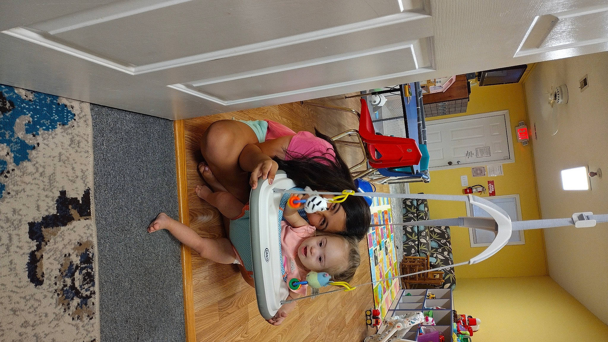 Annabelle is registered to the contest to win money with this photo: baby, bed, child, comfort, flooring, fun, hardwood, hat, house, major_appliance, person, refrigerator, room, shelf, shelving, t_shirt, thigh, toddler, visual_arts, wood