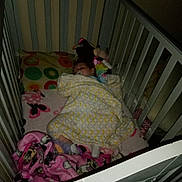 Layla is registered to the contest to win money with this photo: baby, bedroom, blanket, child, comfort, cot, cozy, crib, furniture, indoor, infant, person, pillow, plush, rest, sleep, sleeping, soft_lighting, stuffed_toy, toddler