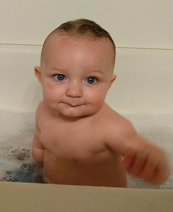 Maverick is registered to the contest to win money with this photo: baby, baby_bathing, bathing, bathroom, bathtub, cheek, chest, child, eye, eyebrow, fluid, foam, fun, human_body, iris, nose, person, plumbing, thumb, toddler