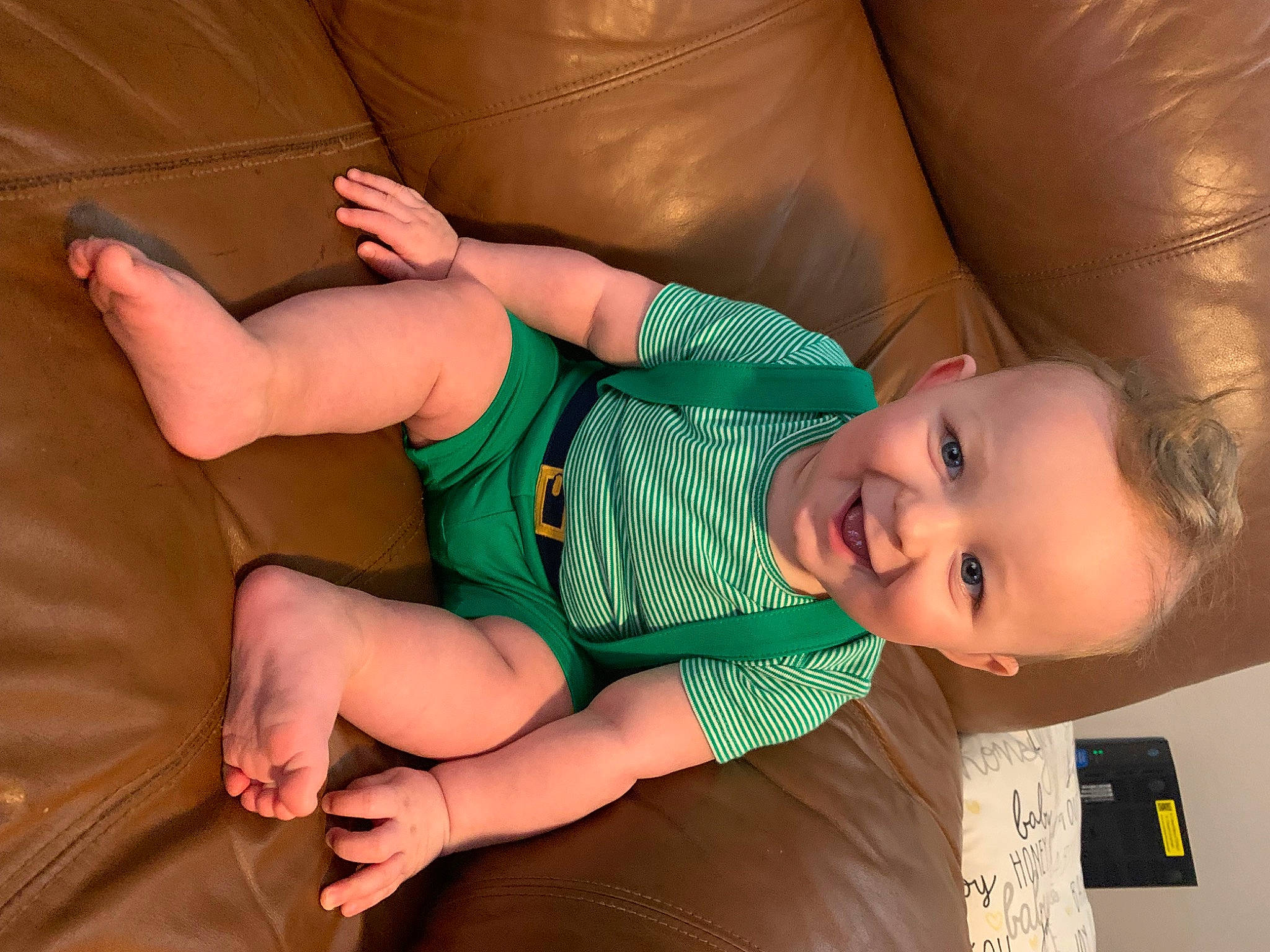 Maverick is registered to the contest to win money with this photo: baby_toddler_clothing, cheek, comfort, eye, finger, gesture, hand, human_body, joint, joy, knee, leg, mammal, mouth, neck, nose, person, skin, textile, thigh