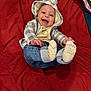 baby, smiling, hoodie, bear_ears, socks, jeans, red_blanket, happy, infant, cute, child, playful, clothing, portrait, indoor, person, baby_clothes, lying_down, cheerful, closeup