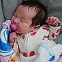 baby, sleeping, pacifier, blanket, onesie, strawberry_pattern, infant, cozy, cute, peaceful, child, indoors, soft, resting, portrait, newborn, comfort, clothing, toddler, face