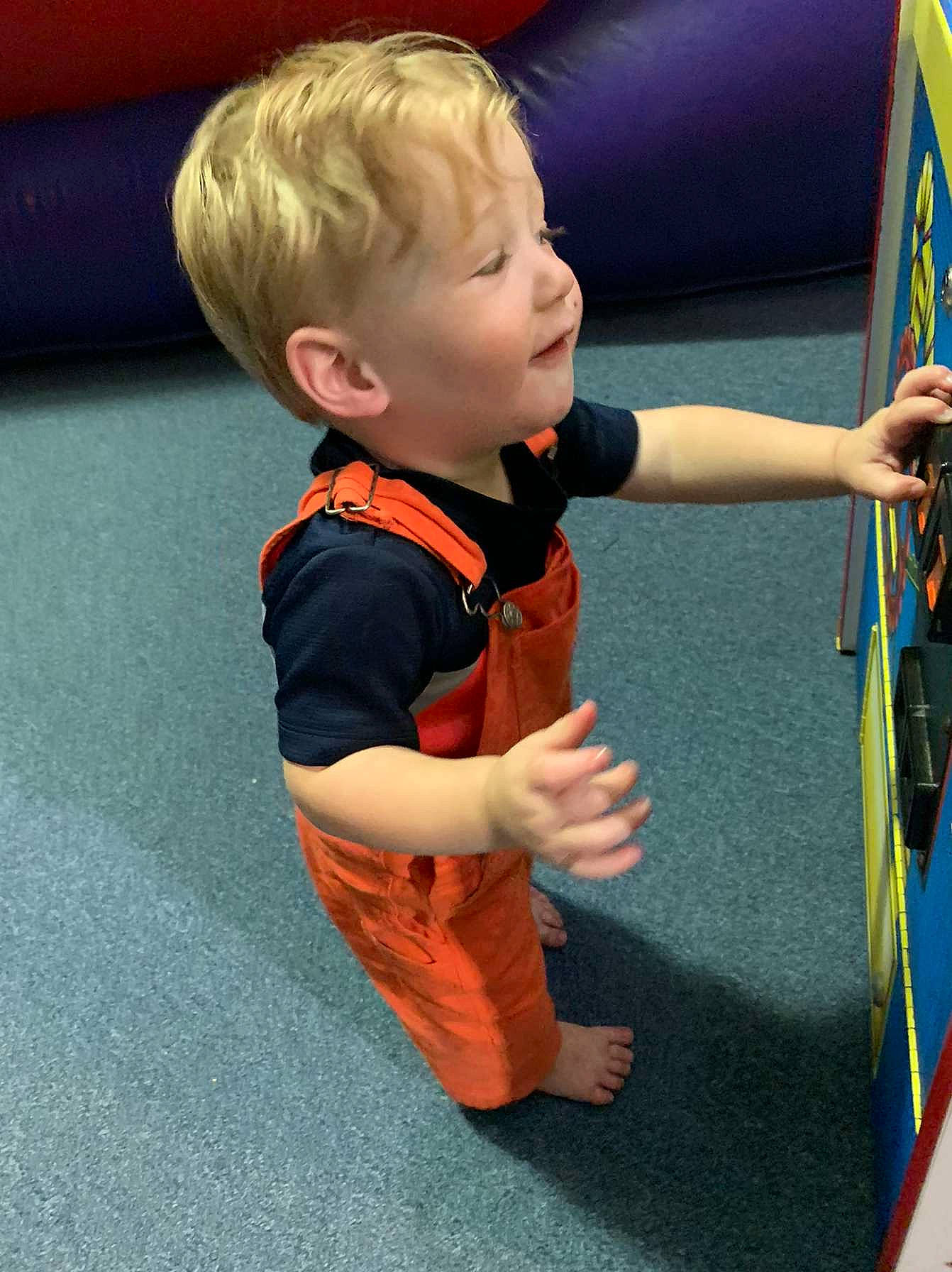 Laken joined the competition — help win amazing prizes! baby, baby_toddler_clothing, child, electric_blue, flooring, fun, gesture, hardwood, human_body, leisure, person, play, recreation, room, sitting, sleeve, t_shirt, toddler, wood