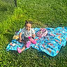 Kaelani is registered to the contest to win money with this photo: accessories, backyard, blanket, child, face, female, girl, grass, head, lawn, nature, outdoors, park, person, photography, plant, portrait, quilt, summer, yard