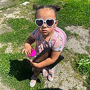 Kaelani is registered to the contest to win money with this photo: accessories, child, clothing, face, female, footwear, girl, glasses, grass, head, nature, outdoors, park, person, photography, plant, portrait, shorts, summer, sunglasses