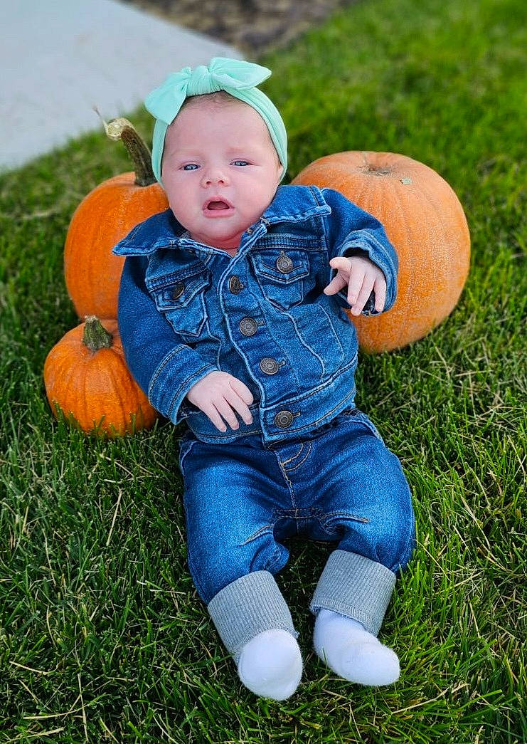 August is registered to the contest to win money with this photo: baby_toddler_clothing, calabaza, child, eye, face, facial_expression, grass, happy, head, lawn, leaf, leg, natural_foods, people_in_nature, person, plant, pumpkin, toddler, tree, vegetable