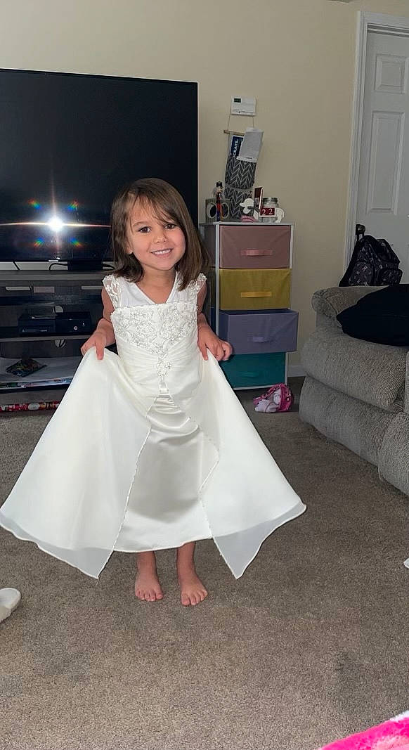 Nevaeh is registered to the contest to win money with this photo: bridal_clothing, bridal_party_dress, couch, day_dress, dress, event, fashion_design, flash_photography, floor, flooring, formal_wear, gown, happy, human_leg, joy, one_piece_garment, person, sandal, shoulder, smile