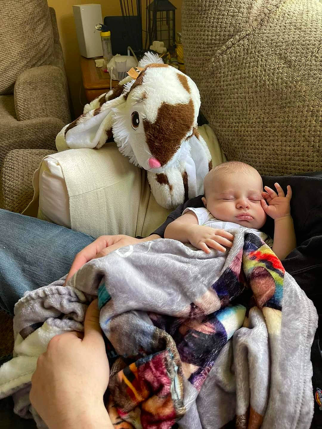 Waylon is registered to the contest to win money with this photo: baby, baby_carriage, baby_products, baby_toddler_clothing, cheek, child, comfort, companion_dog, couch, fur, human_body, human_leg, lap, linens, nap, person, room, sitting, thigh, toddler