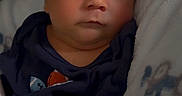 Mikah joined the competition — help win amazing prizes! baby, infant, face, portrait, blanket, clothing, indoors, cute, child, newborn, expression, young, person, skin, head, hair, eyes, cozy, warm, resting
