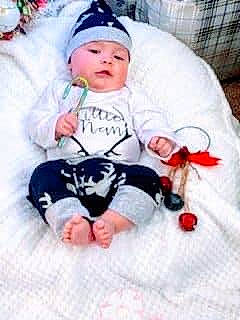 River joined the competition — help win amazing prizes! baby, baby_safety, baby_sleeping, baby_toddler_clothing, cheek, child, comfort, event, face, happy, head, headwear, human_body, lap, leg, person, pink, sleeve, sock, t_shirt