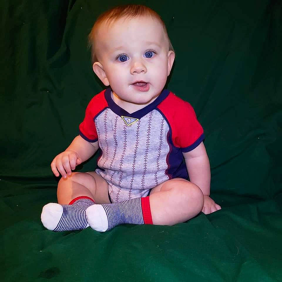 Holden is registered to the contest to win money with this photo: baby, baby_toddler_clothing, cheek, child, child_model, footwear, leg, pattern, person, plaid, play, shoe, sitting, skin, sleeve, smile, toddler