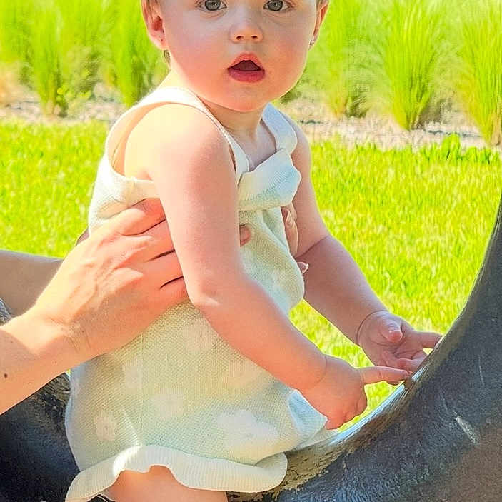 Oaklyn joined the competition — help win amazing prizes! baby, backyard, clothing, dress, face, grass, head, lawn, nature, outdoorplayarea, outdoors, park, person, photography, plant, playarea, portrait, sitting, summer, yard