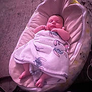 Dani joined the competition — help win amazing prizes! baby, baby_lounger, blanket, child, comfort, cozy, cute, footwear_absent, hands_near_face, indoors, infant, nursery, peaceful, pink_tone, portrait, resting, sleeping, soft_lighting, toddler, wrapped