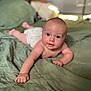 arm, baby, bed, blanket, child, cute, diaper, eyes, face, furniture, hand, home, indoors, infant, lying_down, person, skin, smile, soft, young