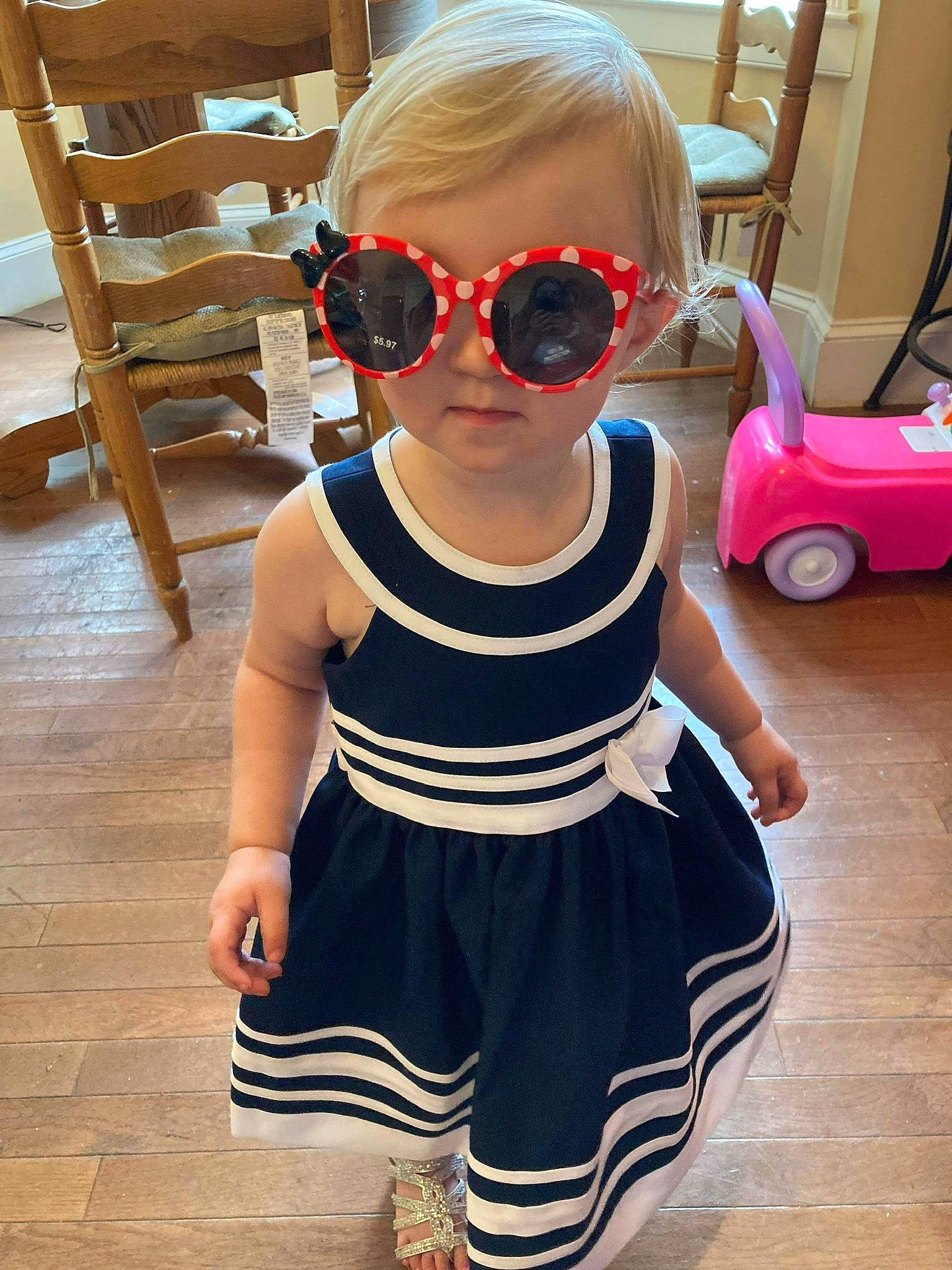 Harmony is registered to the contest to win money with this photo: baby_toddler_clothing, chair, cool, day_dress, eyewear, flooring, glasses, goggles, human_leg, person, shoulder, sleeve, sunglasses, t_shirt, tire, toddler, vehicle, vision_care, waist, wheel