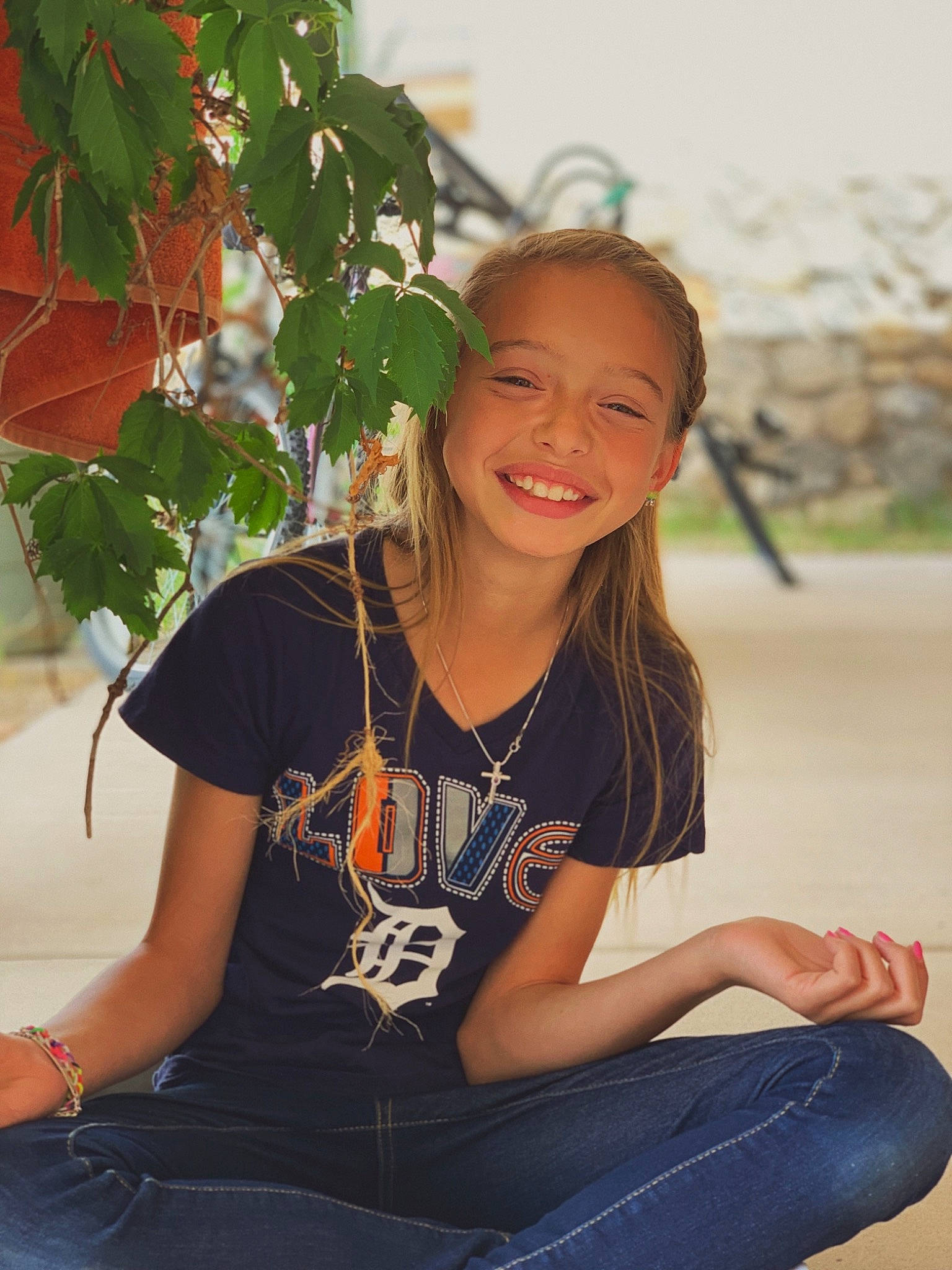 Kaelynn is registered to the contest to win money with this photo: child, fawn, hair, hairstyle, happy, jeans, joy, leisure, long_hair, person, photo_shoot, photography, plant, shorts, sitting, smile, style, summer, t_shirt, top