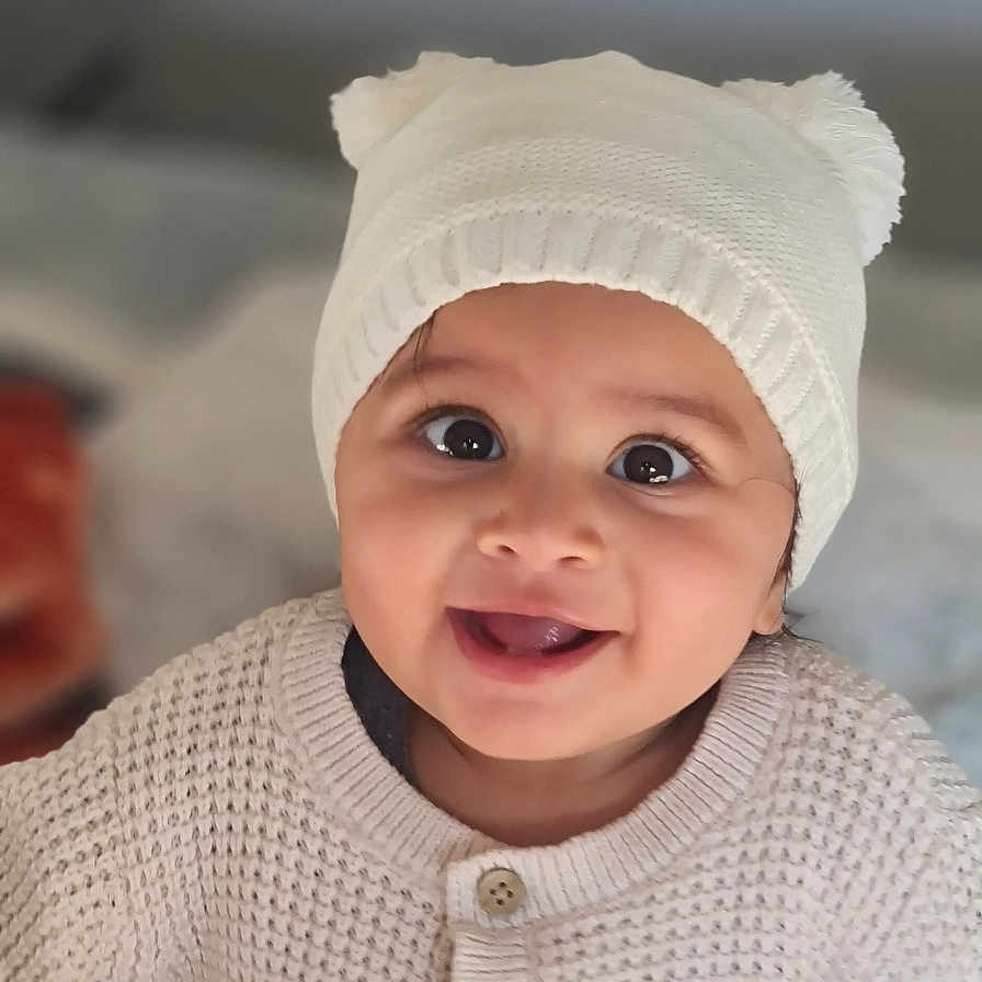 Tabeya joined the competition — help win amazing prizes! baby, button, child, clothing, cozy, cute, expression, face, happy, hat, indoors, infant, knitted, person, pom_pom, portrait, smiling, sweater, warm, white