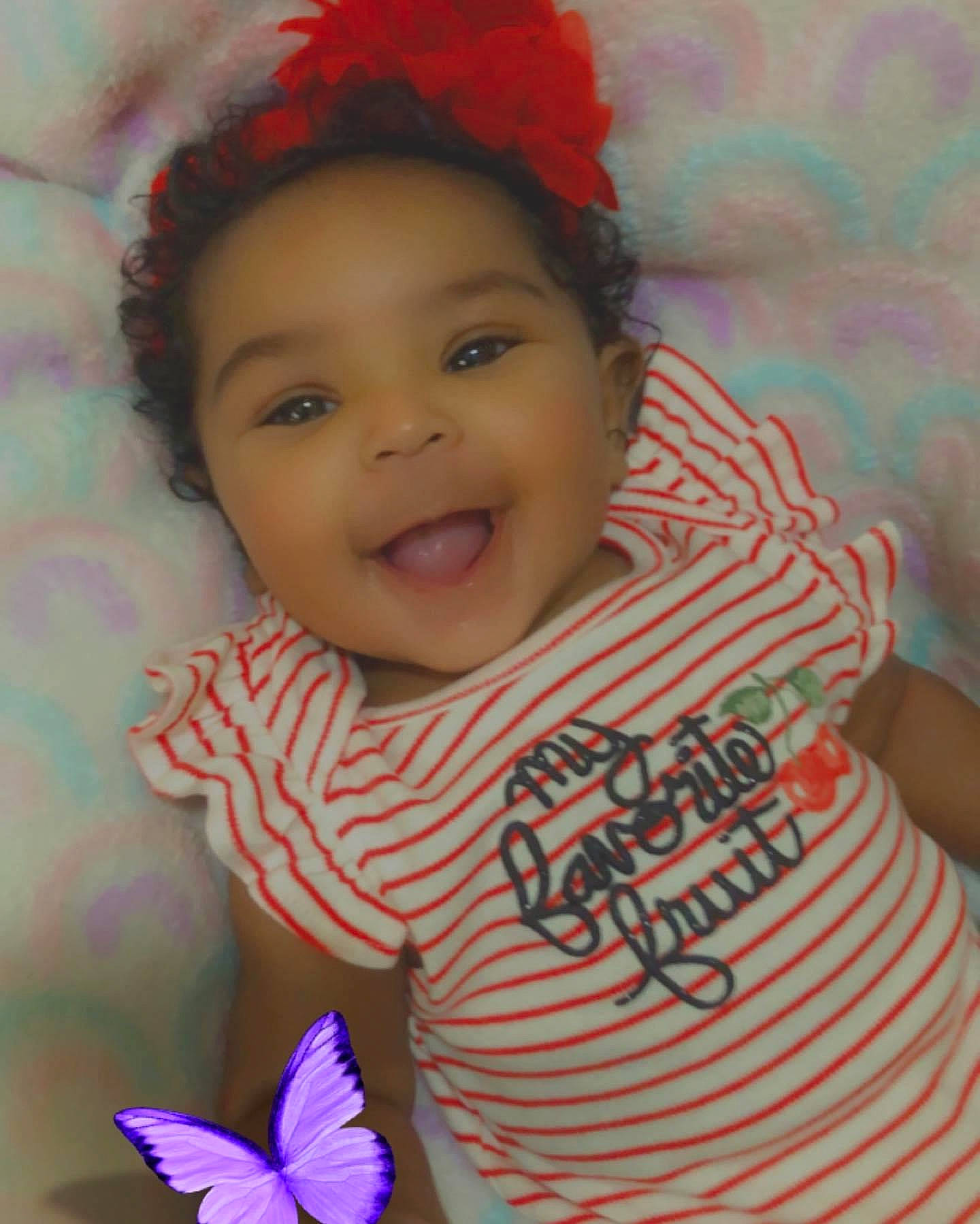 Amya is registered to the contest to win money with this photo: baby_toddler_clothing, blue, cheek, chin, eye, eyebrow, facial_expression, hairstyle, happy, human, joy, lip, mouth, nose, organ, person, purple, skin, sleeve, smile