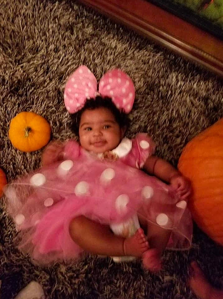 Amya joined the competition — help win amazing prizes! baby_toddler_clothing, comfort, eye, facial_expression, fawn, finger, happy, head, human_body, iris, leg, mouth, nose, orange, people_in_nature, person, pink, skin, textile, toy