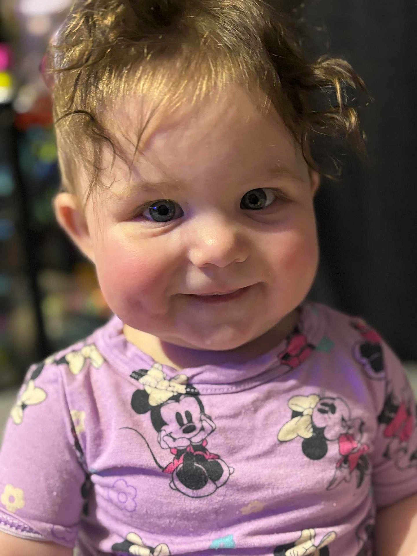 Kinnora joined the competition — help win amazing prizes! child, toddler, face, curly_hair, smile, purple_clothing, minnie_mouse, cartoon_print, indoor, closeup, cute, happy, young_child, person, portrait, baby, cheeks, expression, apparel, casual_wear