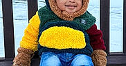 Kevin is registered to the contest to win money with this photo: toddler, child, bench, winter, snow, coat, hood, gloves, jeans, sneakers, smile, outdoor, cold_weather, cute, fashion, playful, face, park, seasonal, happy