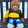 toddler, child, bench, winter, snow, coat, hood, gloves, jeans, sneakers, smile, outdoor, cold_weather, cute, fashion, playful, face, park, seasonal, happy
