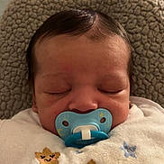 George joined the competition — help win amazing prizes! baby, pacifier, blanket, sleeping, face, head, infant, cute, cozy, comfort, child, smile, star_pattern, soft, rest, indoors, clothing, texture, closeup, portrait